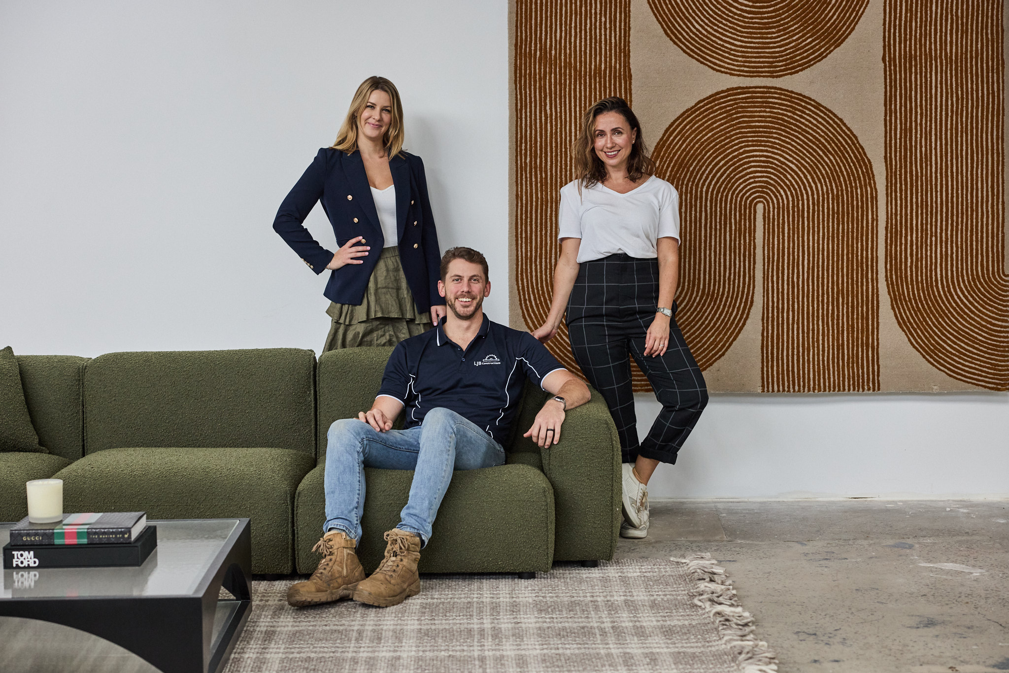 Luma Developments A modern living room features a green sofa, complemented by a large abstract artwork on the wall.